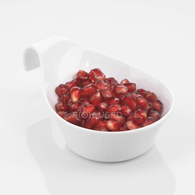 Pomegranate seeds in dish — Stock Photo