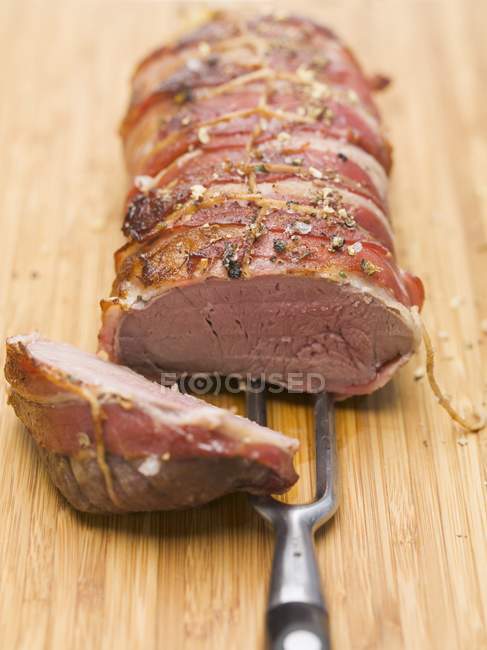 Bacon-wrapped leg of venison — Stock Photo