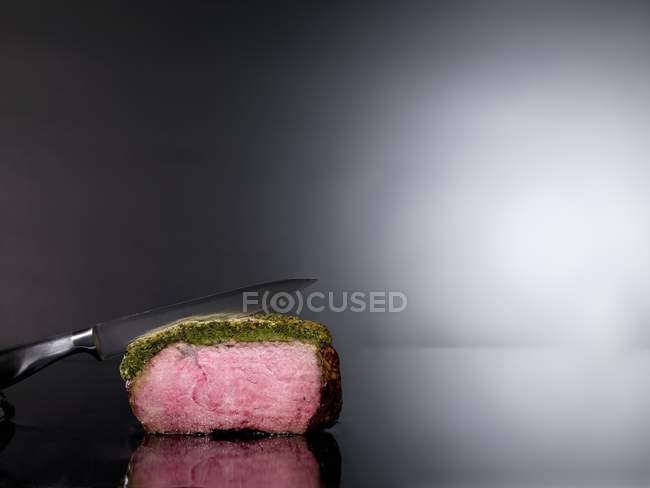 Roasted beef with knife — Stock Photo