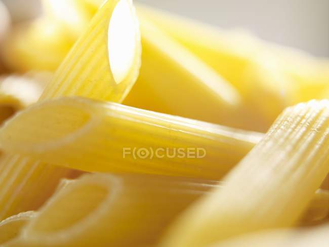 Raw penne pasta — Stock Photo