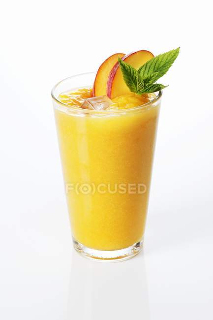 Peach smoothie with peach slices — Stock Photo