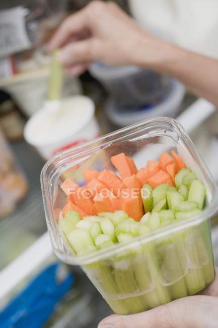 Woman dipping celery — Stock Photo