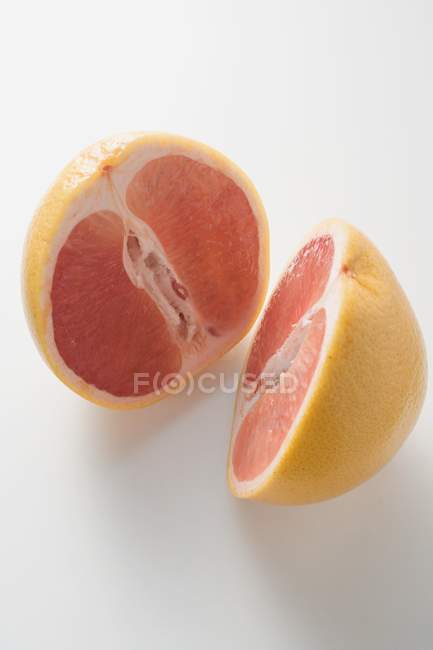 Pink grapefruit on white — Stock Photo
