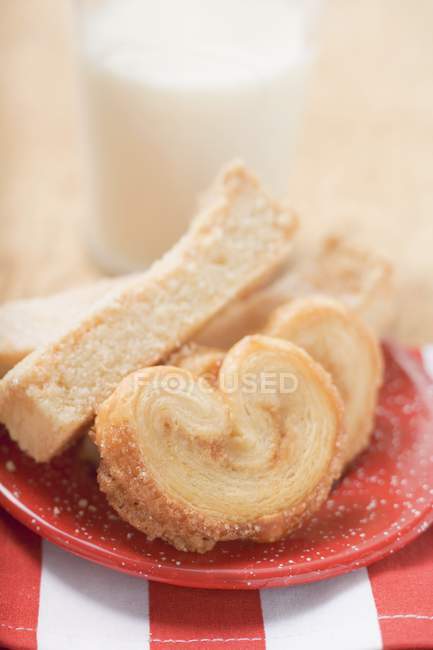 Sweet pastries on red plate — Stock Photo