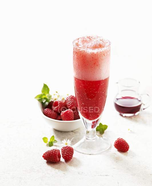 Champagne cocktail with raspberries — Stock Photo