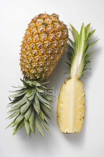 Whole pineapple with wedge of pineapple — Stock Photo