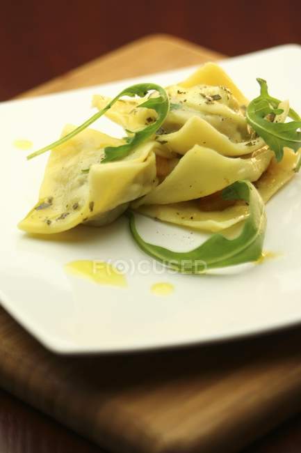 Pumpkin ravioli pasta with arugula — Stock Photo