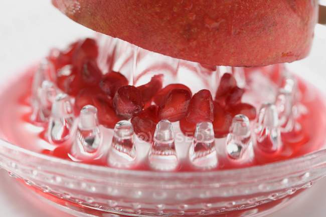 Pomegranate fruit on squeezer — Stock Photo