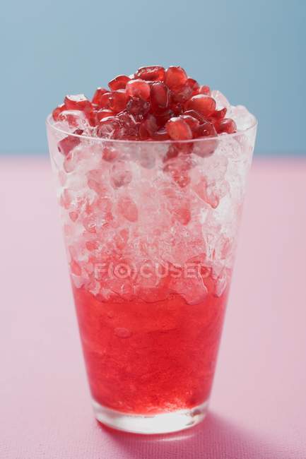 Glass of pomegranate juice with ice — Stock Photo