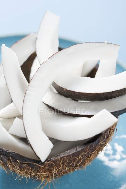 Pieces of coconut in hollowed-out coconut — Stock Photo
