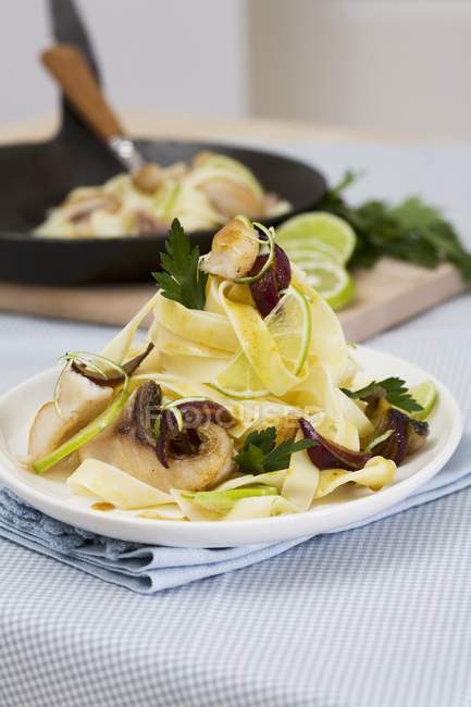 Tagliatelle pasta with carp and lime — Stock Photo