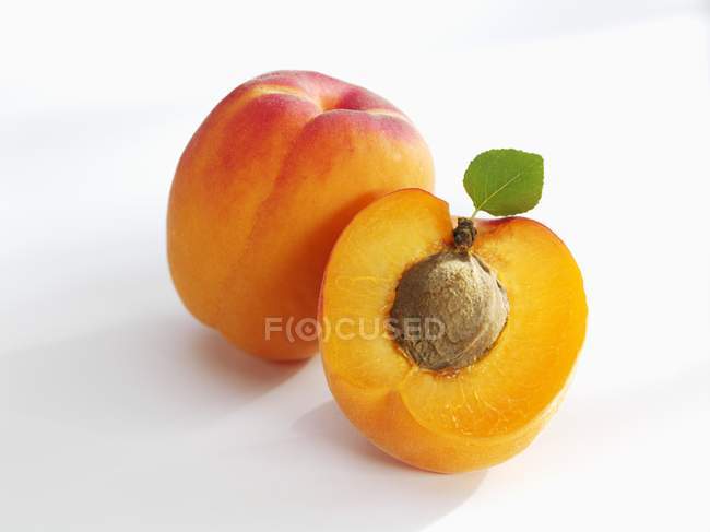 Fresh ripe apricot with half — Stock Photo
