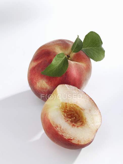 White-flesh peaches whole and halved — Stock Photo