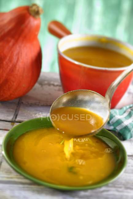 Pumpkin soup plate with ladle — Stock Photo