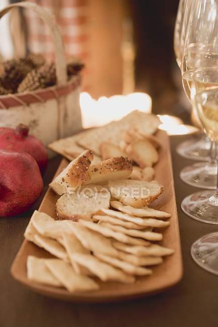 Bread on platter over table — Stock Photo