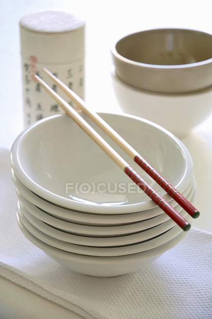 Elevated view of stacked bowls with chopsticks — Stock Photo