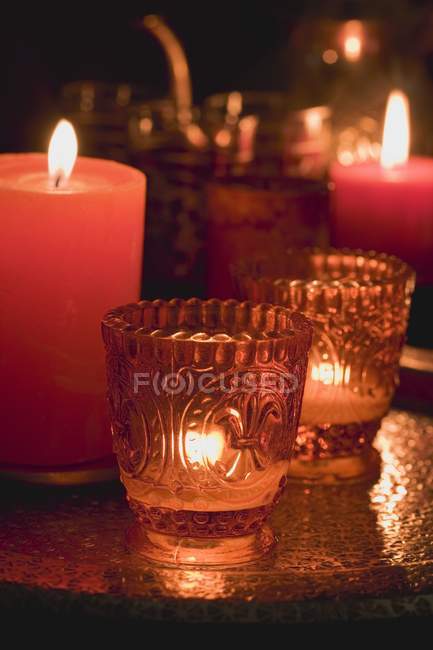 Closeup view of lit candles and windlights — Stock Photo