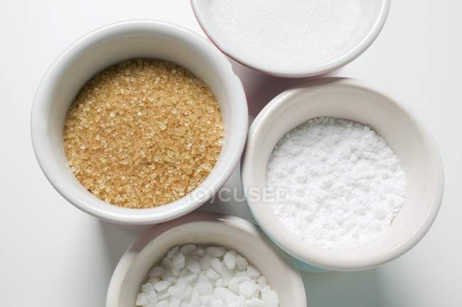 Closeup top view of four different types of sugar — Stock Photo