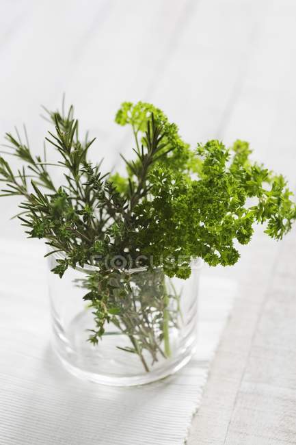 Rosemary and thyme in glass — Stock Photo