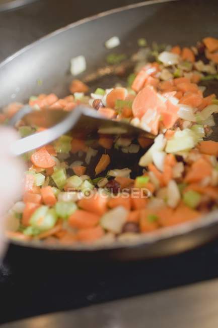 Sauting carrots and celery — Stock Photo