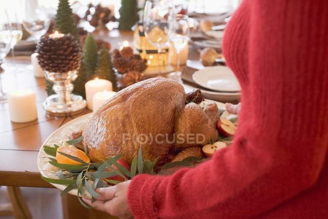 Woman serving roast turkey — Stock Photo