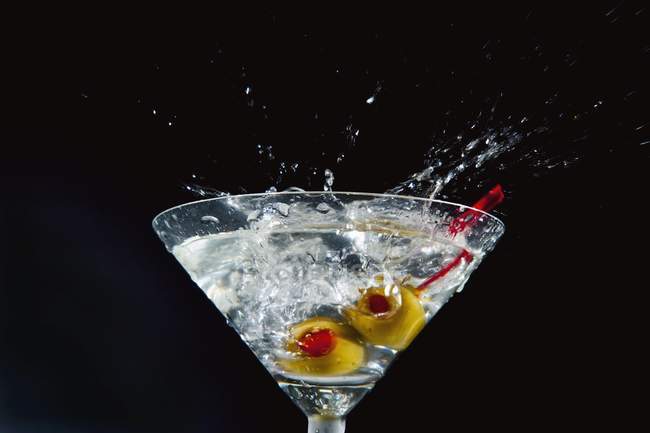 Martini salpicadura con aceitunas - foto de stock
