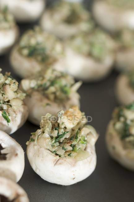 Closeup view of stuffed mushrooms on dark surface — Stock Photo