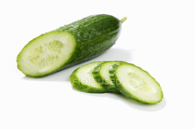 Piece of cucumber and cucumber slices — Stock Photo