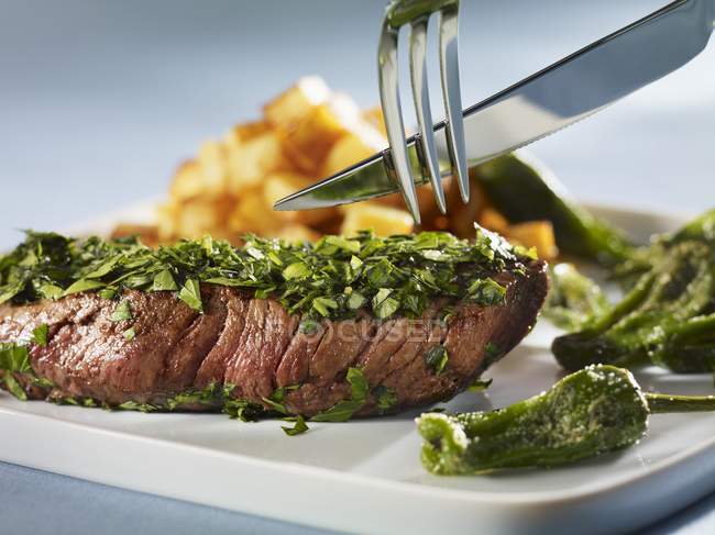Steak coated in herbs — Stock Photo