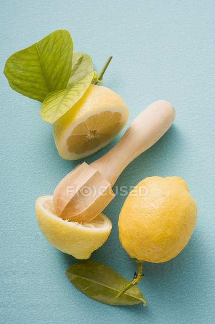 Pressez la moitié du citron avec un presse-agrumes — Photo de stock