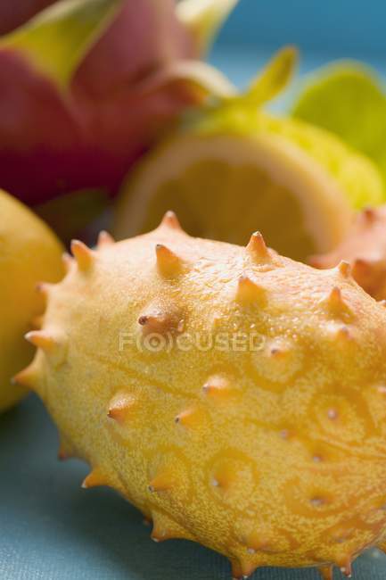 Lemons with pitahaya and horned melons — Stock Photo