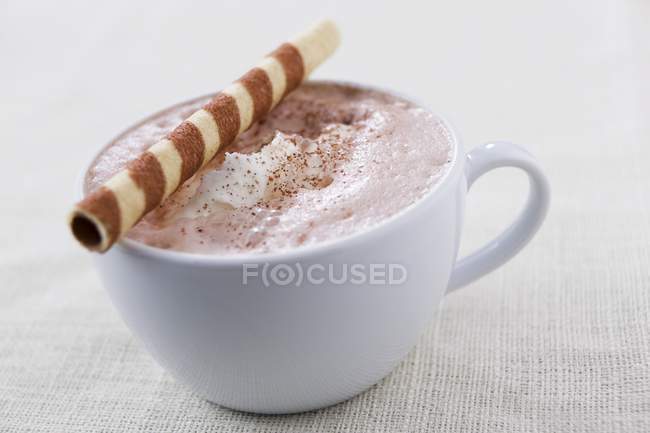 Hot chocolate with wafer roll — Stock Photo