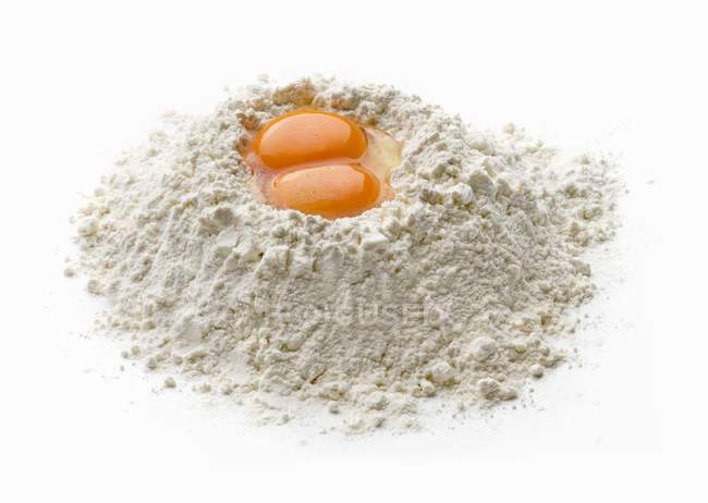 Egg yolks in flour — Stock Photo