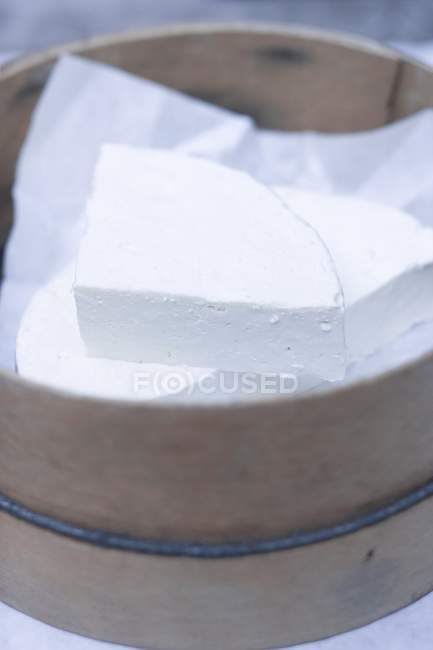 Sheep's cheese on paper — Stock Photo