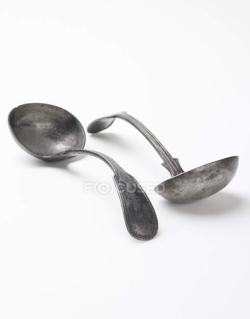 Closeup view of two antique ladles on white surface — Stock Photo