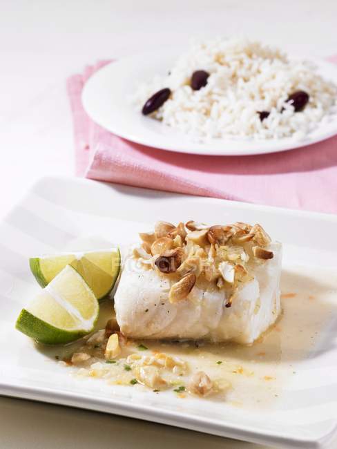 Closeup view of cod fillet with nuts — Stock Photo