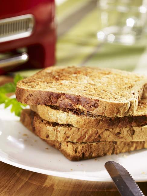 Closeup view of piled slices of toasts on plate — Stock Photo