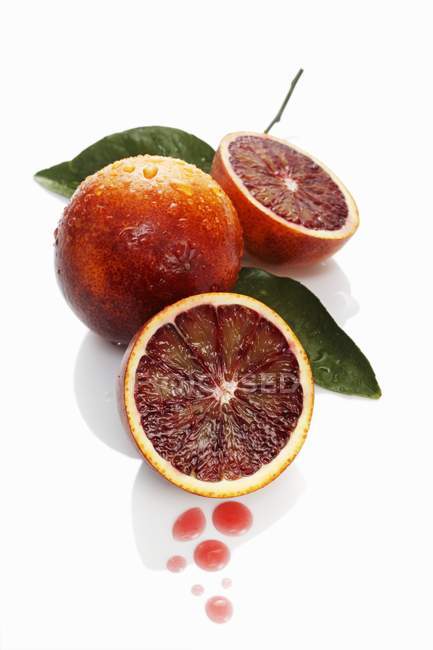 Blood oranges with drops of juice — Stock Photo