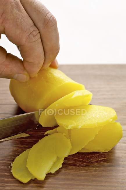 Mains Trancher la pomme de terre bouillie — Photo de stock