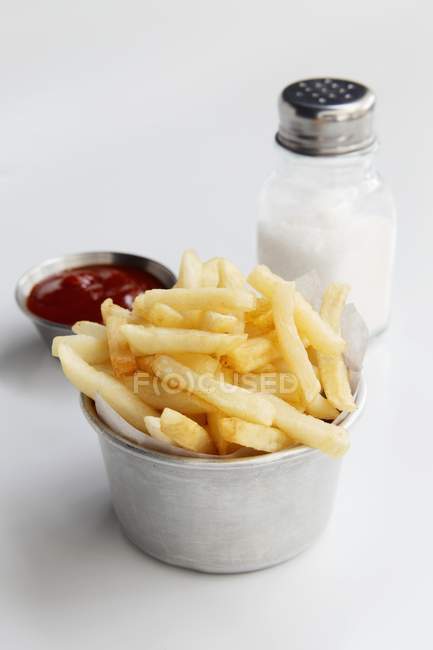 Patatas fritas con salsa de tomate y sal - foto de stock