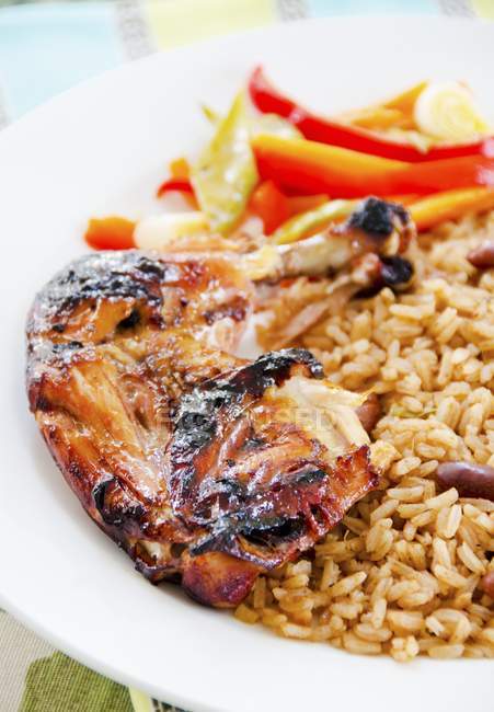 Jerk chicken with beans and rice — Stock Photo