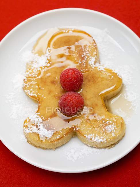 Pancake man with raspberries — Stock Photo