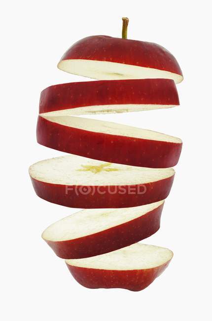 Flying slices of red apple — Stock Photo