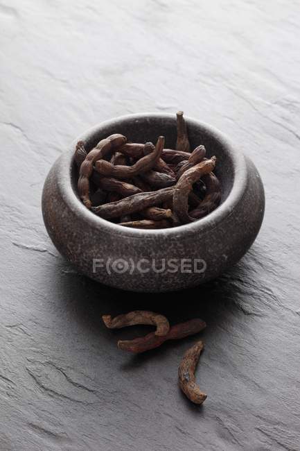 Bowl of dried long pepper — Stock Photo