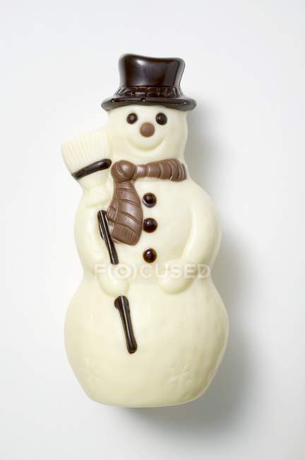 Primo piano vista di pupazzo di neve di cioccolato sulla superficie bianca — Foto stock