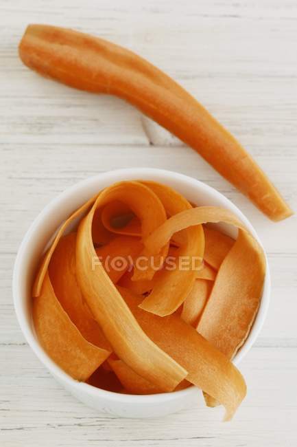 Bowl of grated carrots — Stock Photo