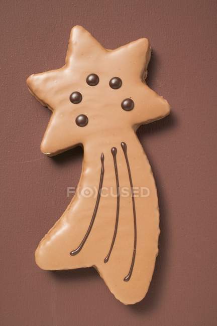 Shooting star biscuit with chocolate icing — Stock Photo