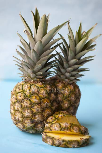 Whole pineapples and slices — Stock Photo