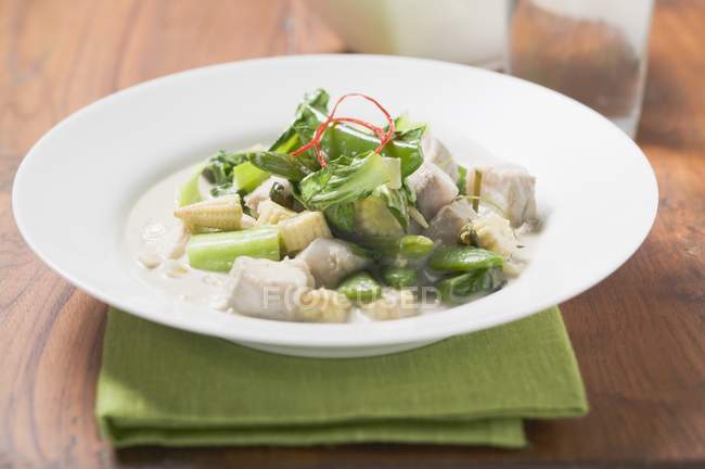 Fish with chard and baby corn cobs — Stock Photo