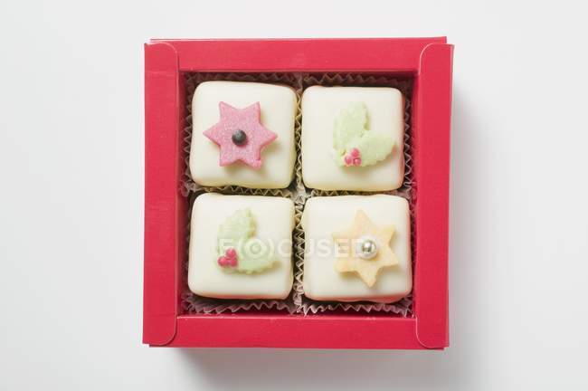 Petit fours in red box — Stock Photo
